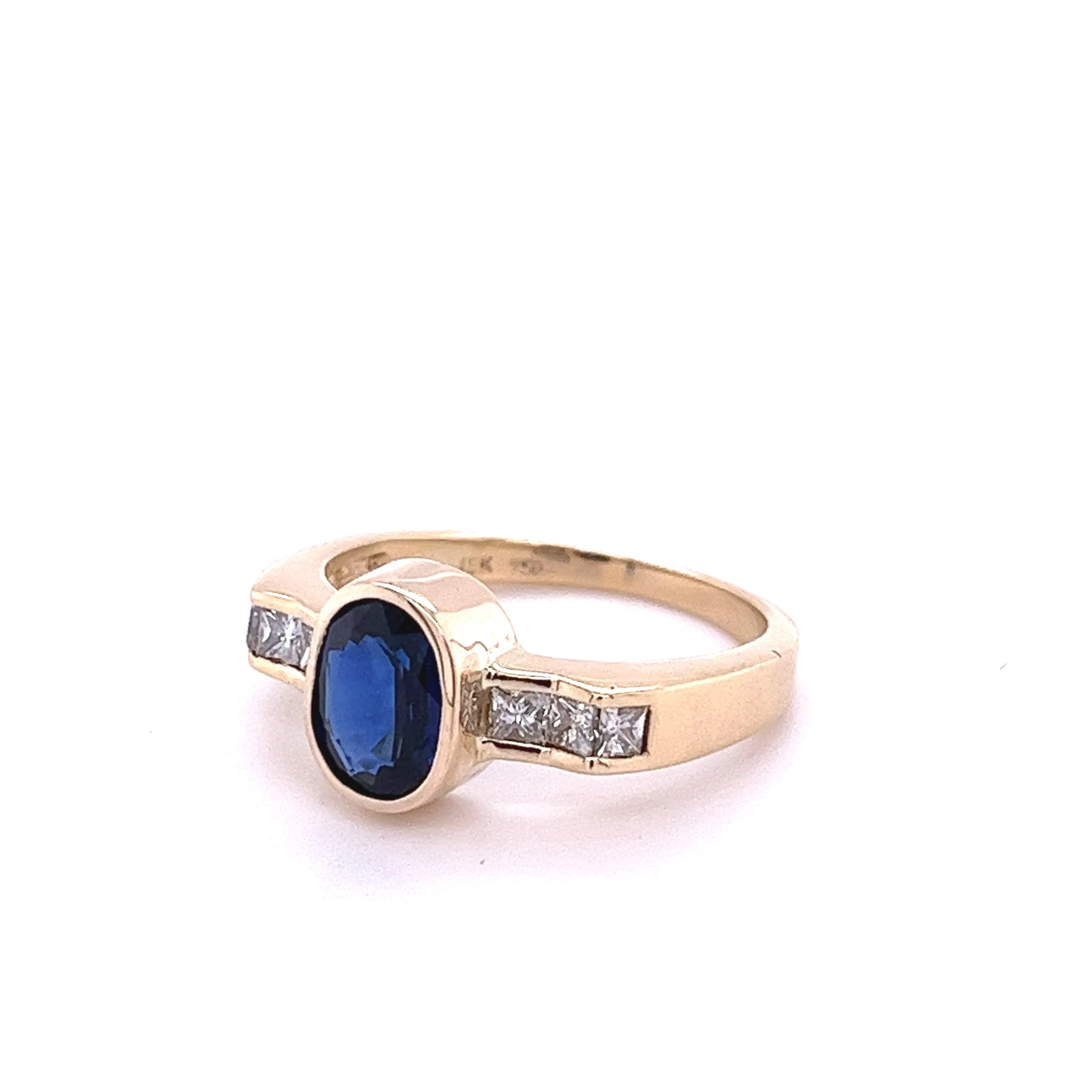 1.48 Carat Oval Cut Blue Sapphire With Princess Cut Diamond Ring in 18k Gold - Image 2